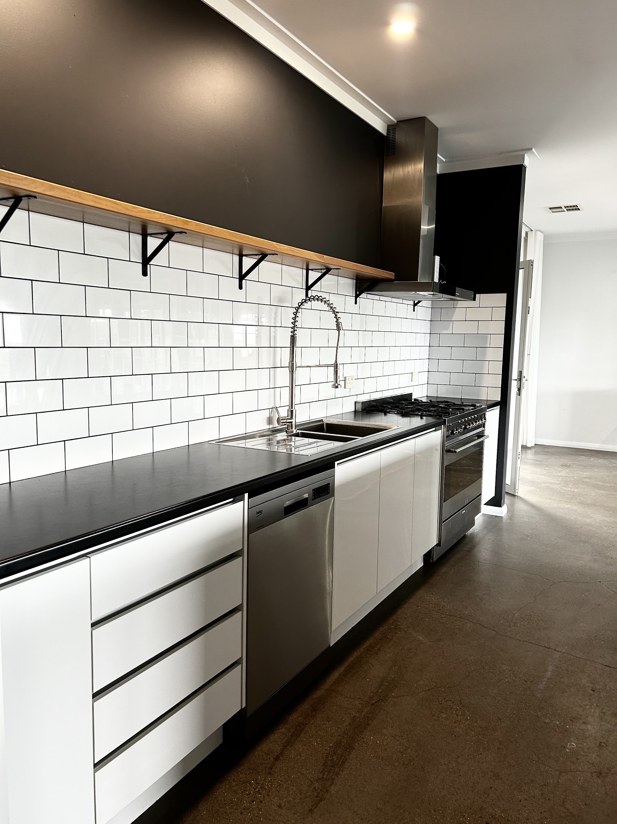 Clean black and white kitchen with polished surfaces