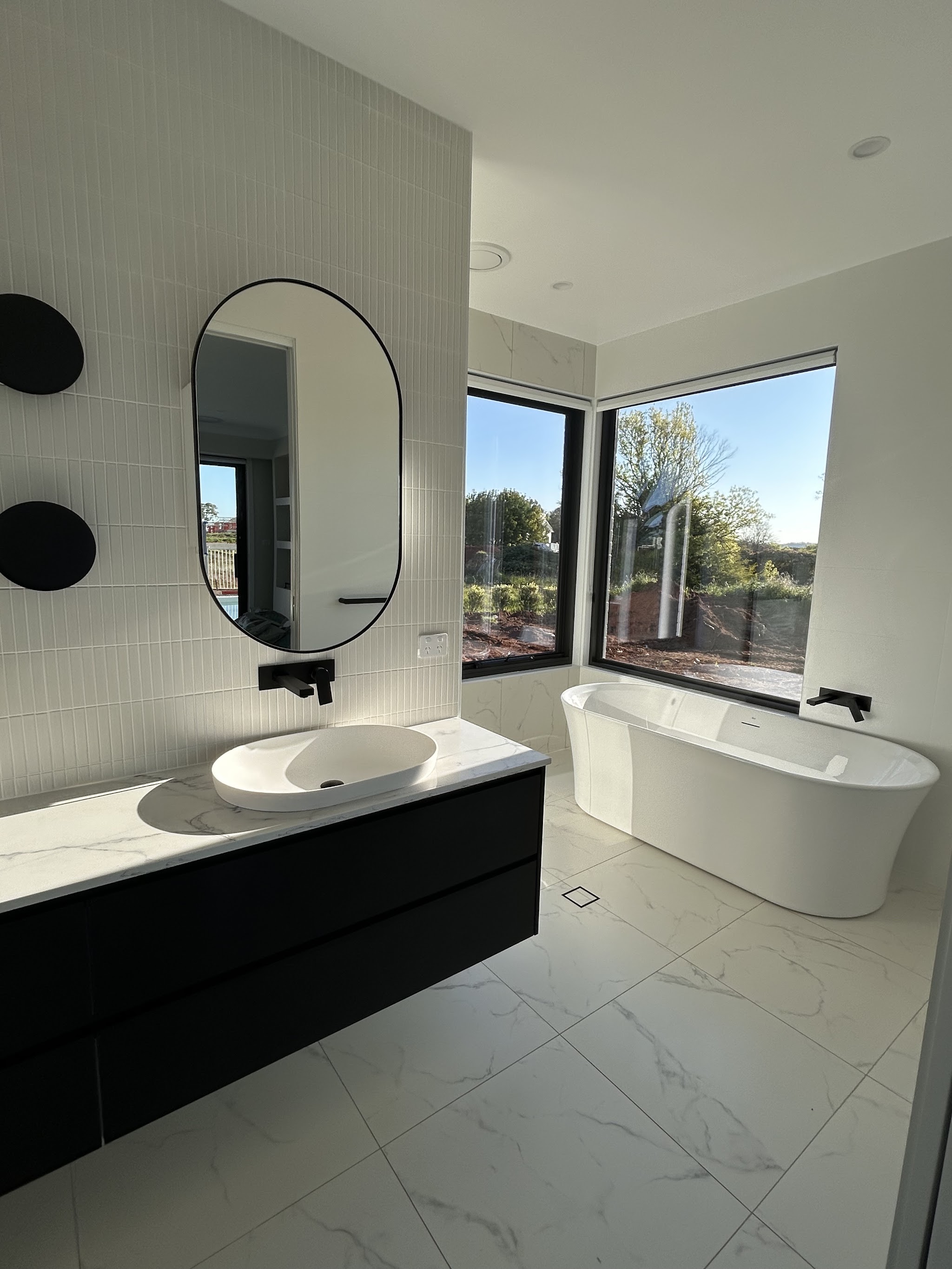 Clean bathroom vanity and freestanding bath