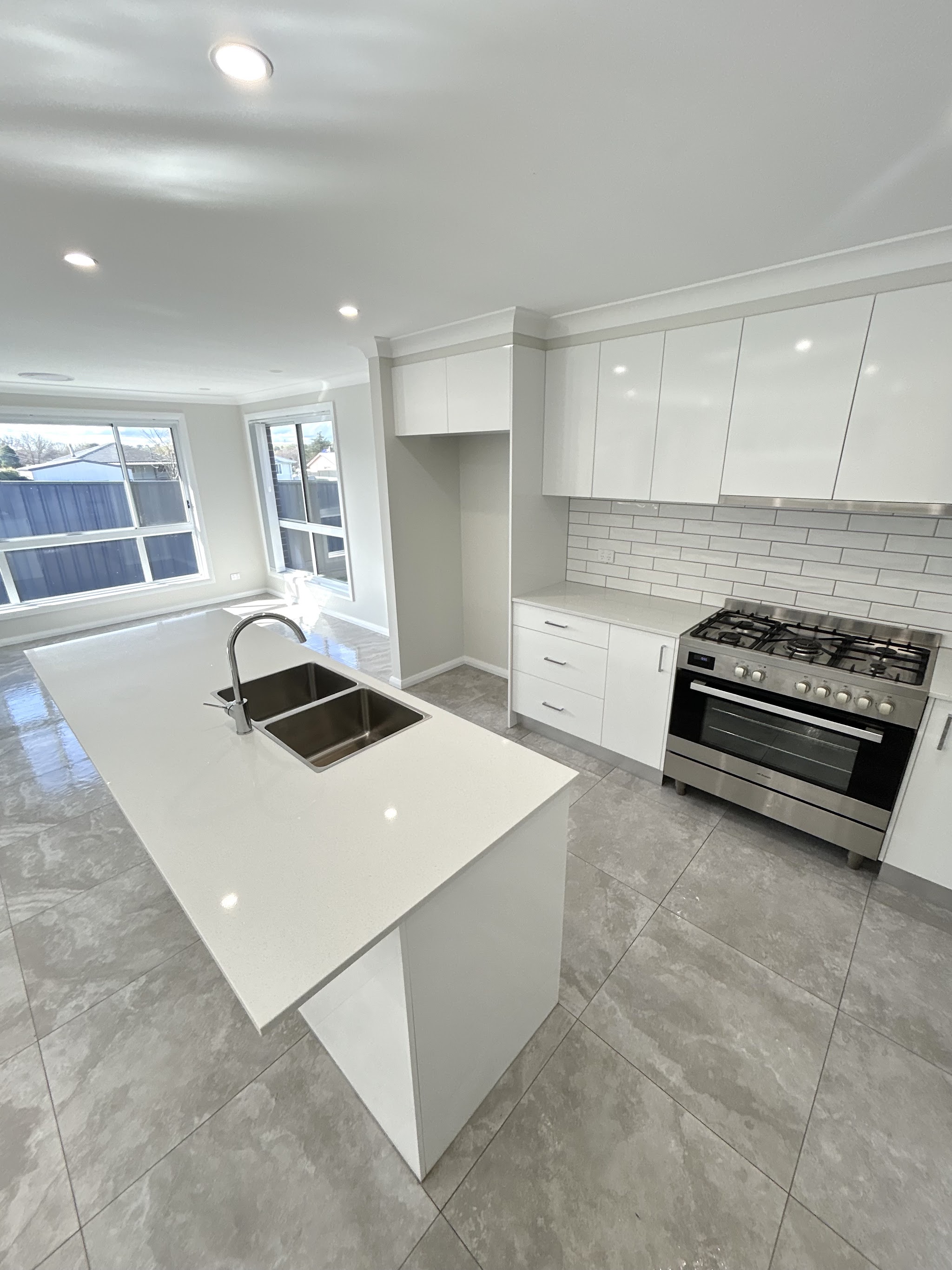 Bright white kitchen with clean bench and floor